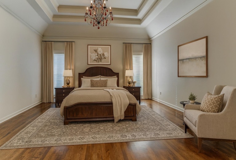 Bedroom with wood finished floors, a chandelier, crown molding, and a raised ceiling