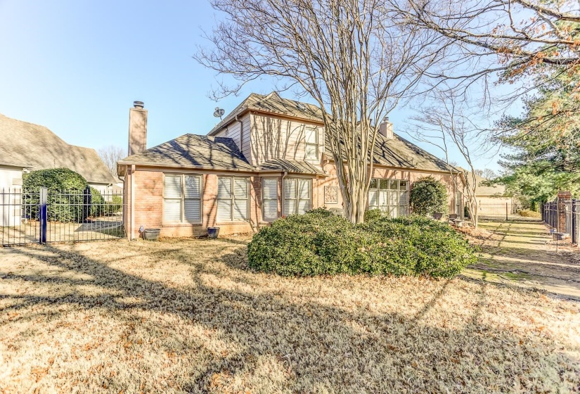Back of property with a yard