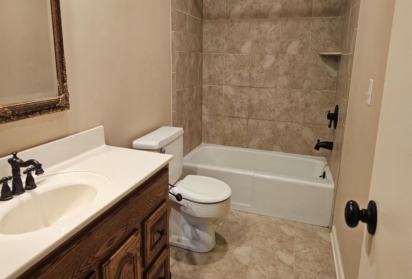 Full bath featuring vanity and shower / washtub combination
