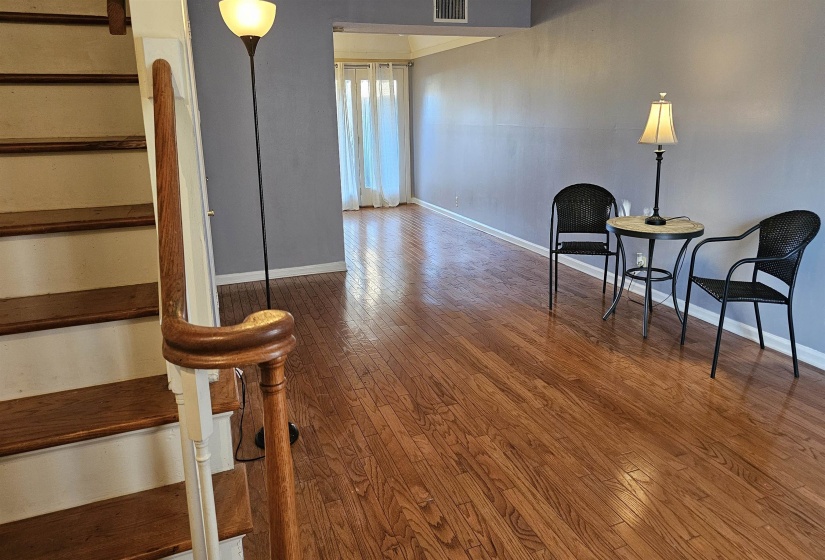 Living area featuring stairway and hardwood / wood-style flooring