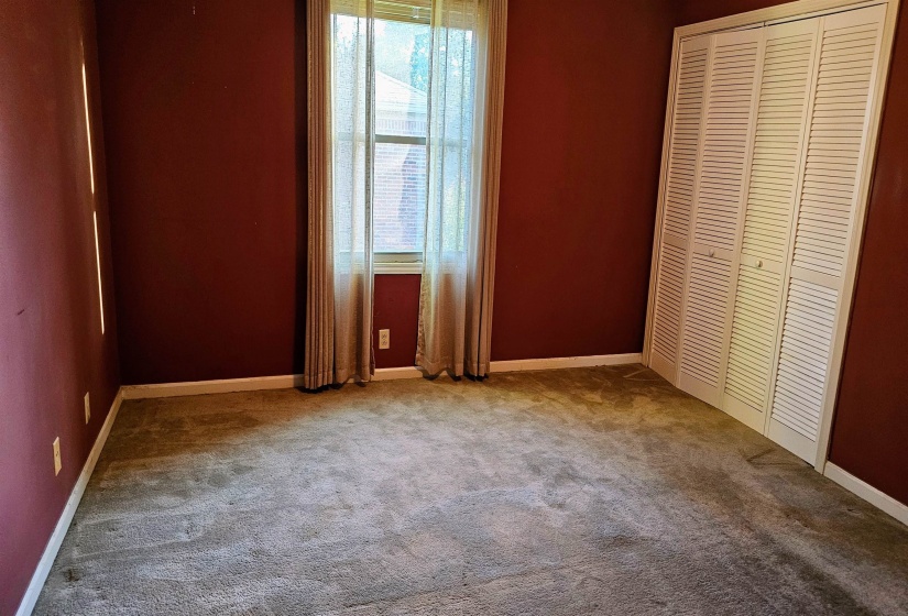 Unfurnished bedroom featuring a closet and carpet