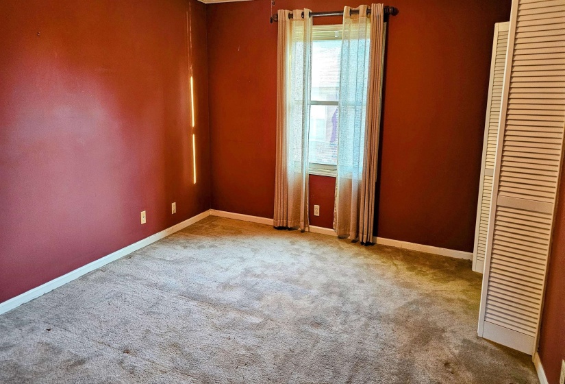 Unfurnished bedroom featuring carpet flooring and baseboards