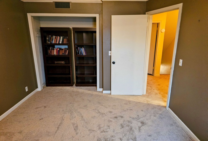 Unfurnished bedroom with carpet flooring, baseboards, and a closet