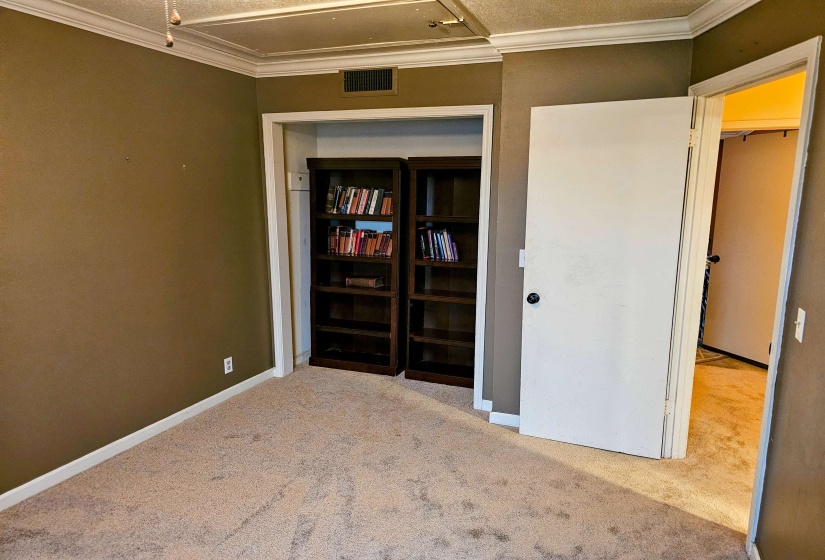 Unfurnished bedroom with carpet, ornamental molding, and baseboards