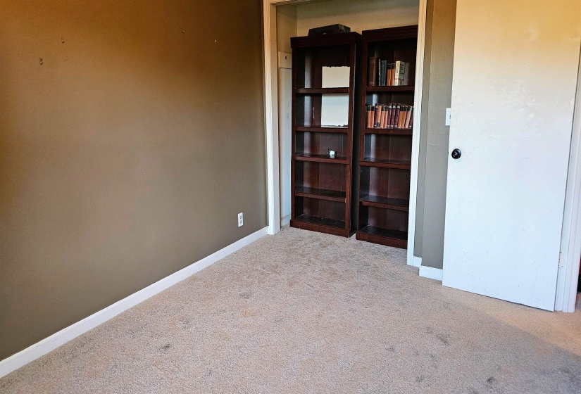 Empty room with light carpet and baseboards