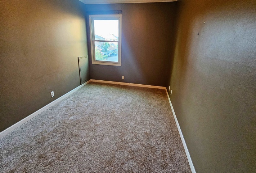 Empty room featuring carpet flooring and ornamental molding