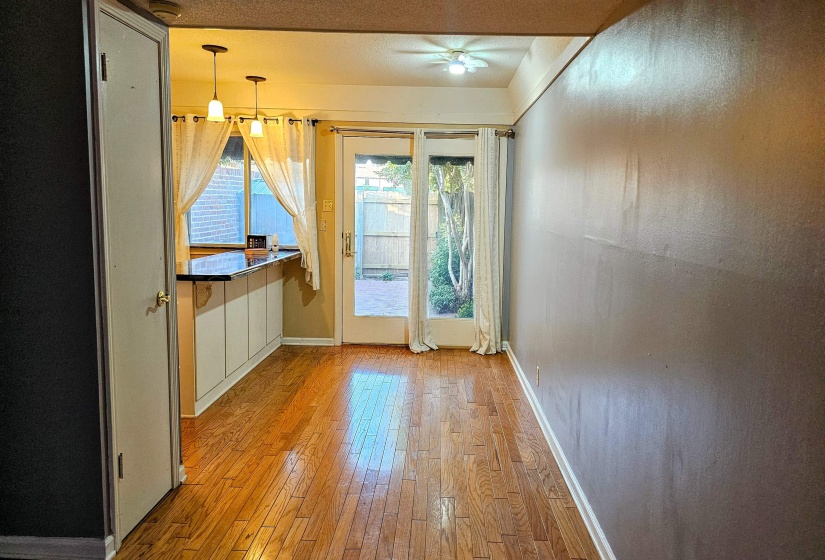 Doorway with baseboards and hardwood / wood-style floors