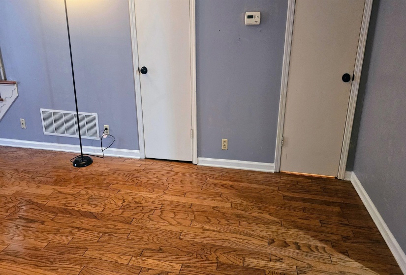 Unfurnished bedroom featuring wood finished floors and baseboards