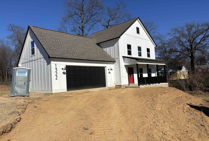 Modern farmhouse style home with a garage and a porch