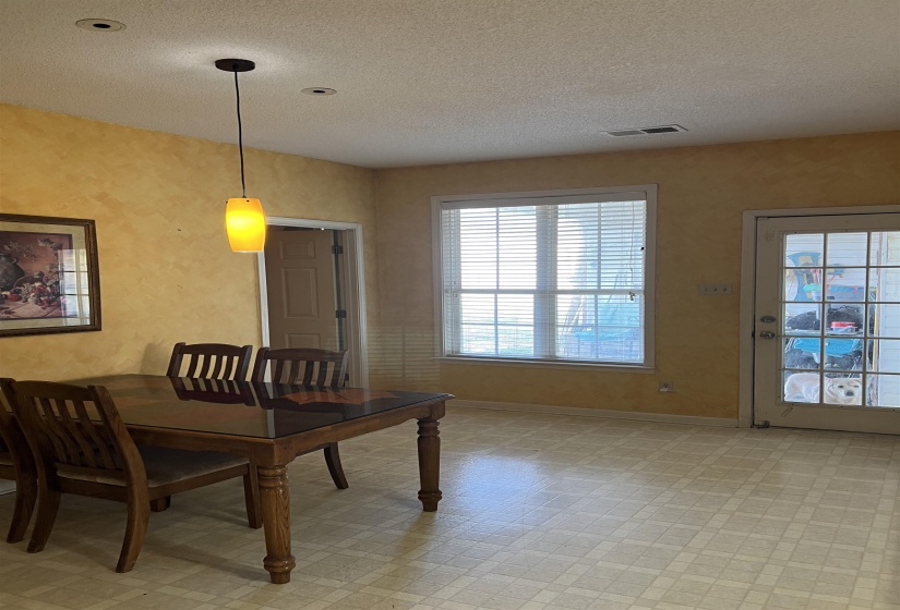 Dining room with a textured ceiling and light floors