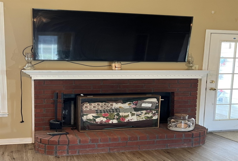 Detailed view of a fireplace and wood finished floors