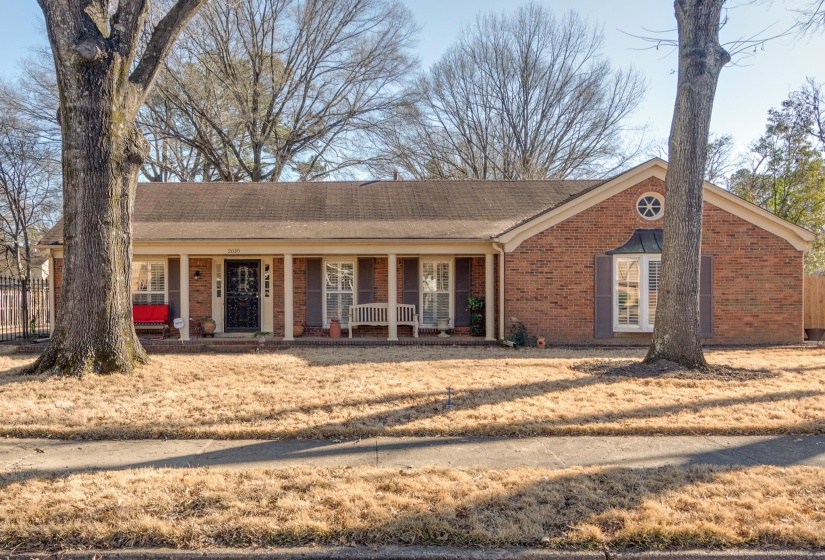 Single story home featuring a porch and brick siding