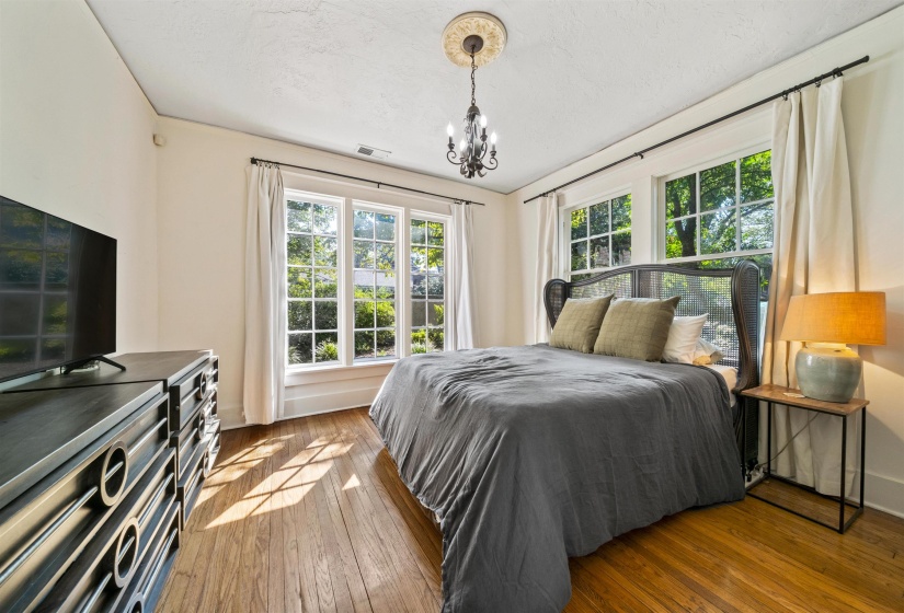 Bedroom featuring hardwood / wood-style floors and a chandelier