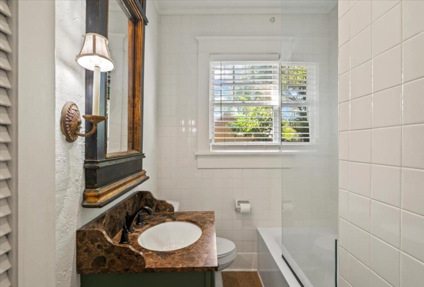 Bathroom with vanity, tile walls, washtub / shower combination, and crown molding