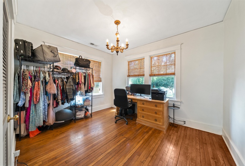 Office area with wood-type flooring and a chandelier
