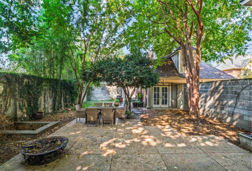 Fenced backyard with french doors, a patio area, a fire pit, and outdoor dining space