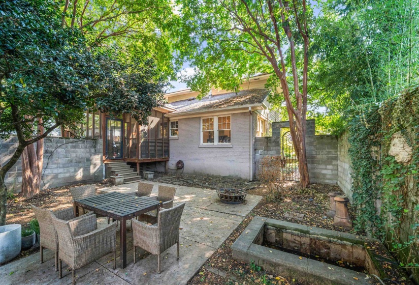 Fenced backyard with a patio area, a deck, and outdoor dining space