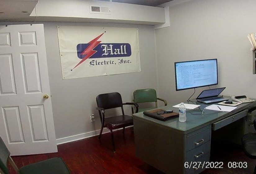 Home office featuring dark wood-style floors and baseboards