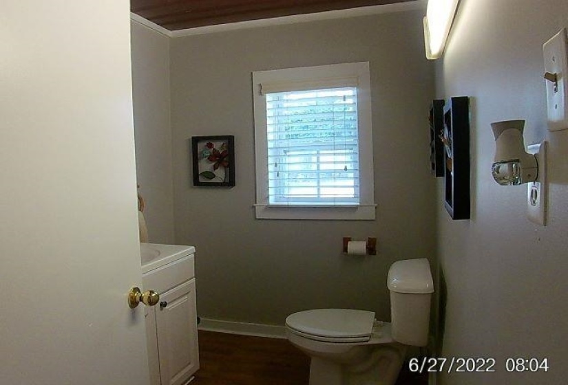 Bathroom with vanity, ornamental molding, and dark wood-type flooring