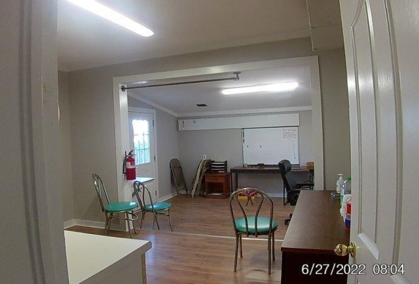 Dining space with light wood-type flooring, a desk, and crown molding