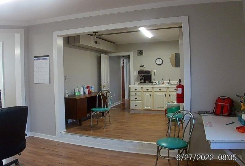 Interior space with light wood-type flooring and crown molding