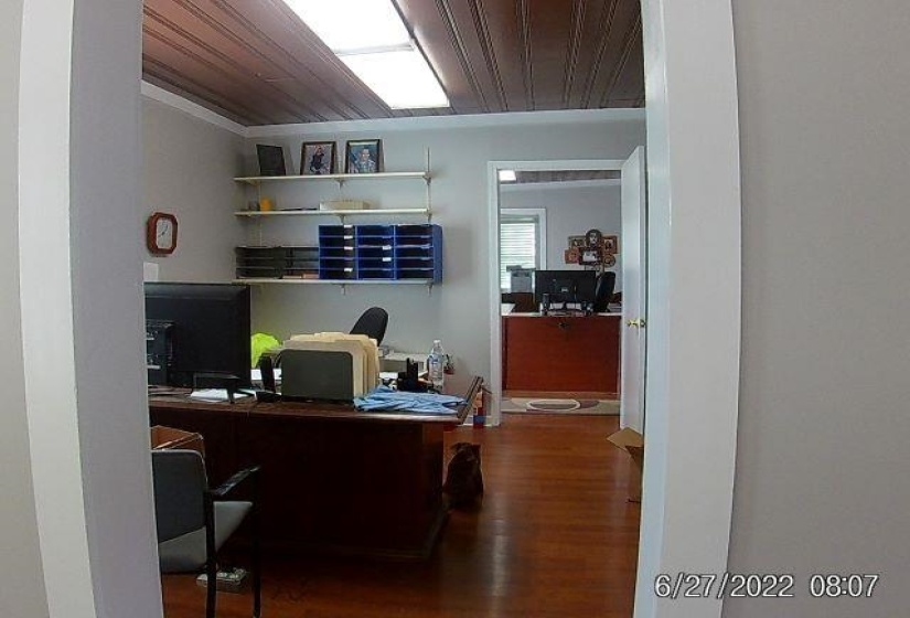 Office with wooden ceiling and wood finished floors