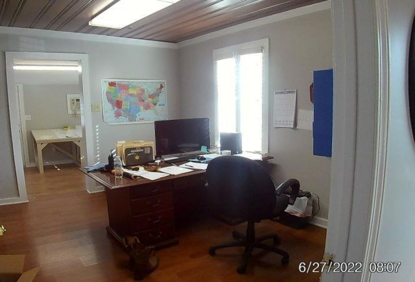 Office area featuring dark wood-type flooring and wood ceiling