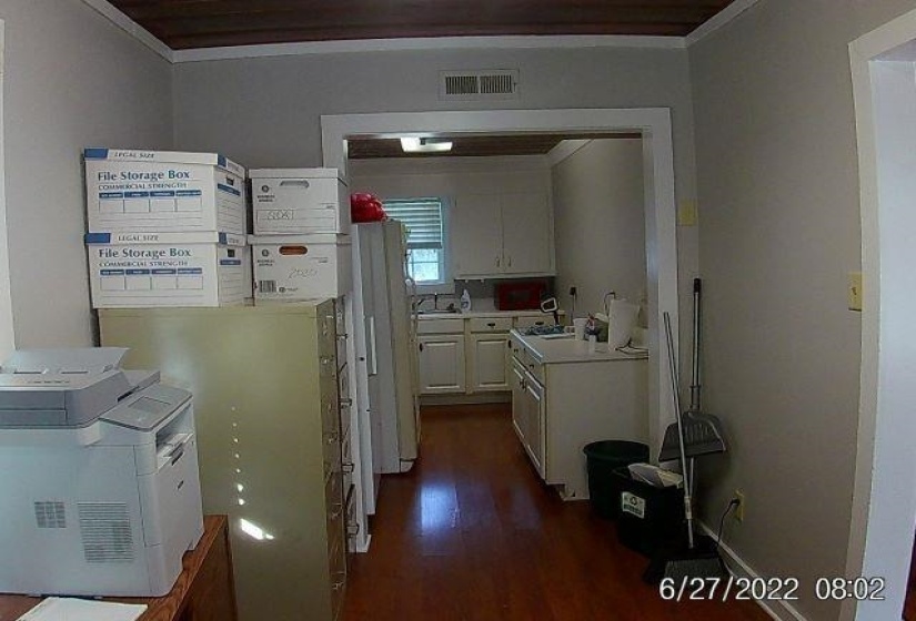 Corridor with ornamental molding, dark wood-type flooring, and washer / clothes dryer