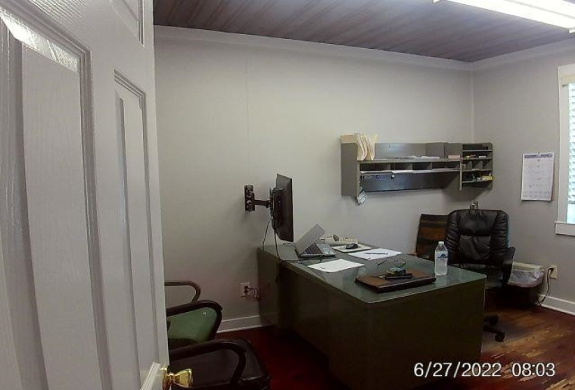 Office with crown molding and dark wood finished floors