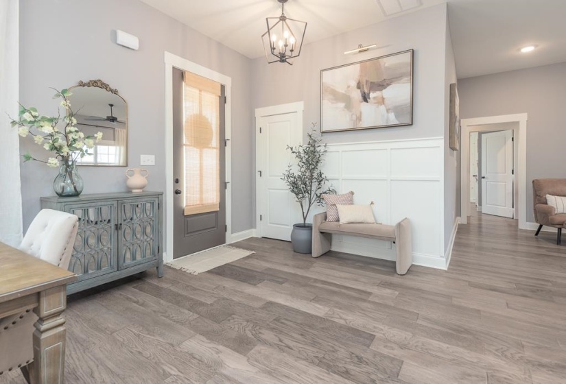Foyer entrance with a chandelier and wood finished floors
