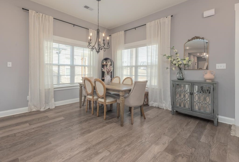 Dining area featuring light wood-style floors and a chandelier