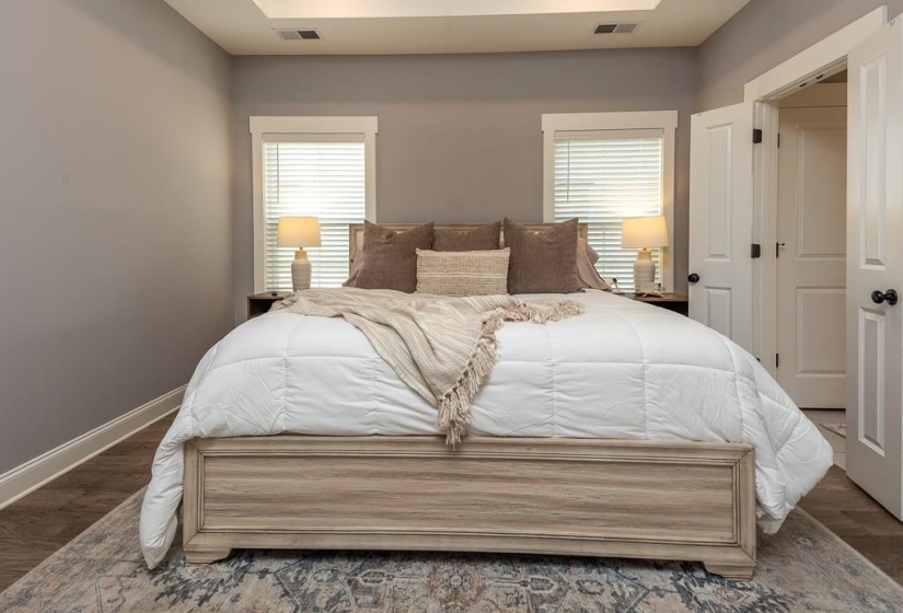 Bedroom featuring multiple windows and wood finished floors