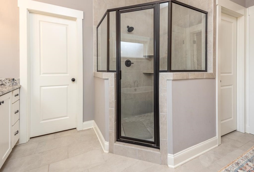 Bathroom featuring vanity, a stall shower, and light tile patterned flooring