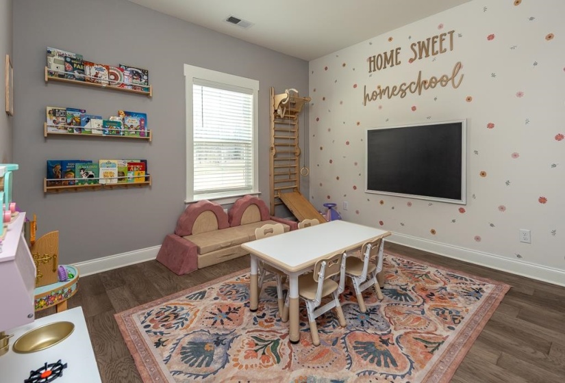 Recreation room featuring dark wood finished floors and wallpapered walls