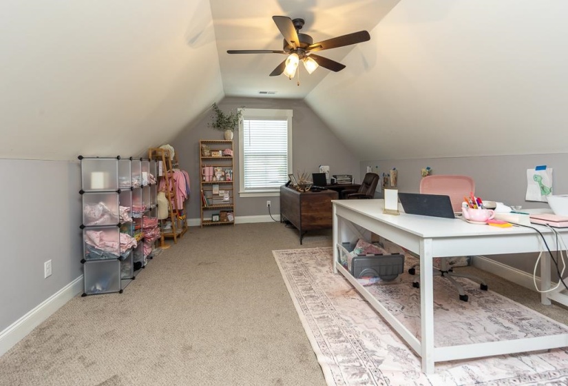 Office with light colored carpet, lofted ceiling, and ceiling fan