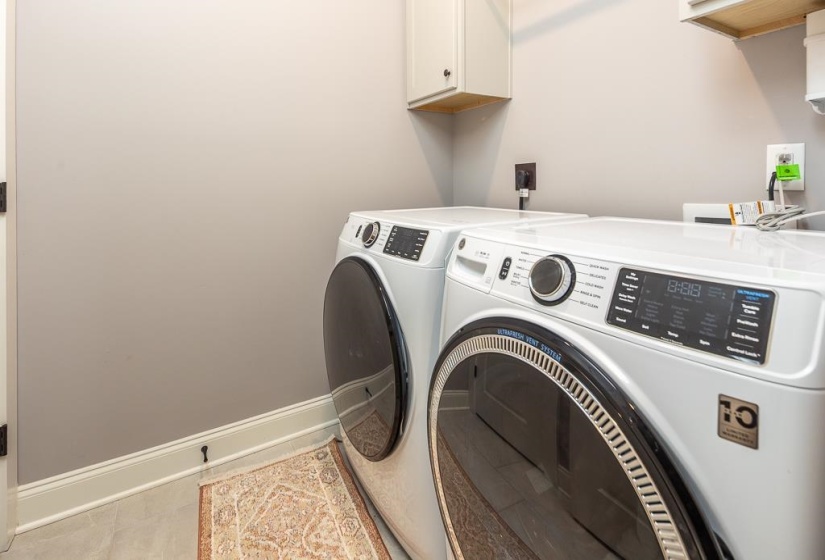 Laundry room featuring baseboards and washing machine and dryer