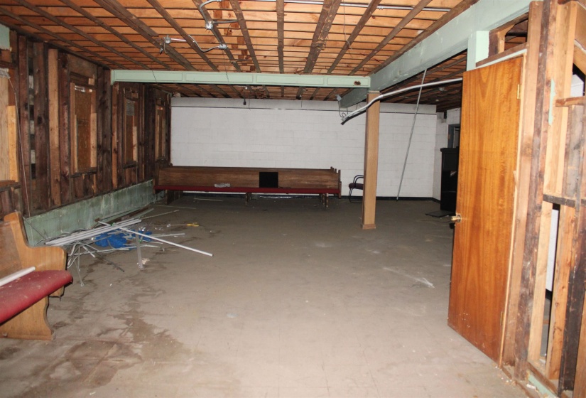 Basement featuring concrete block wall and a garage