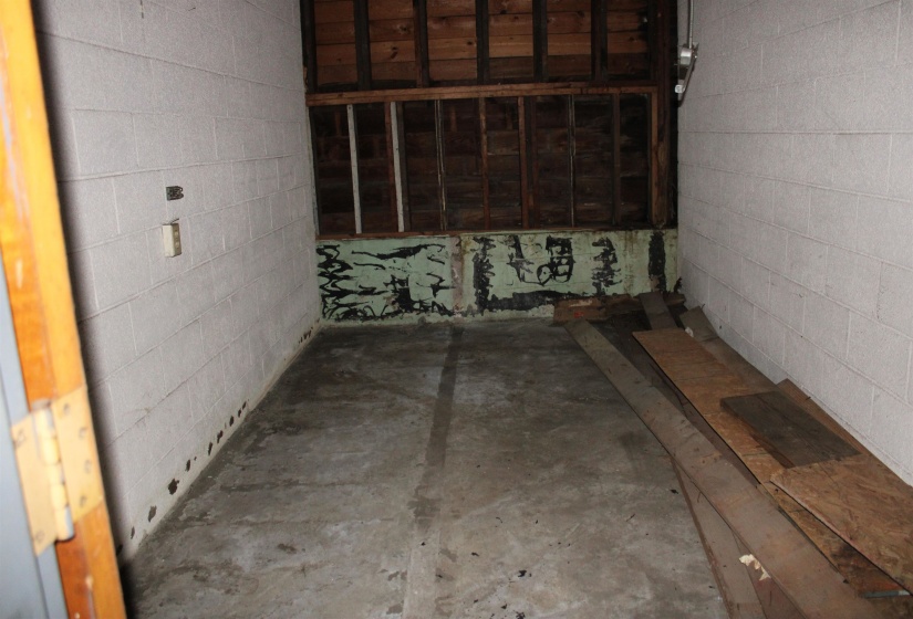 Misc room featuring concrete block wall