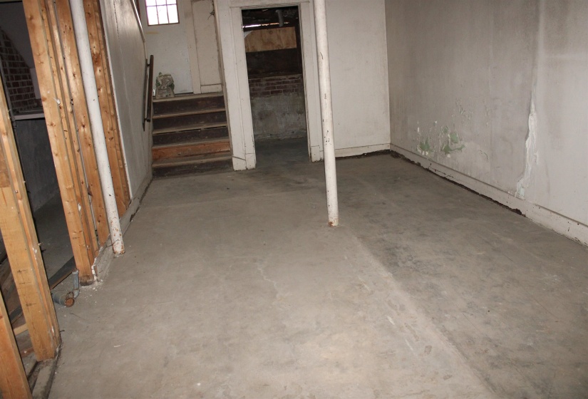 Unfinished below grade area featuring stairs