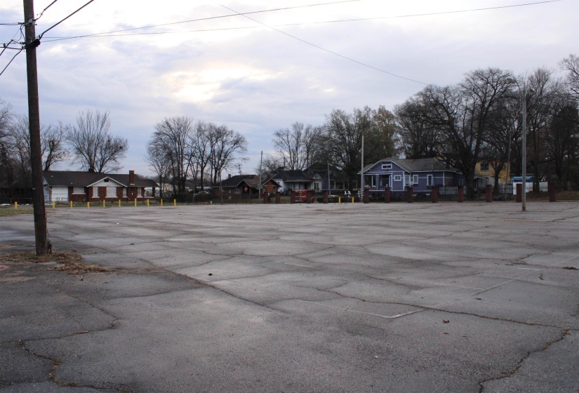 Uncovered parking lot featuring a residential view