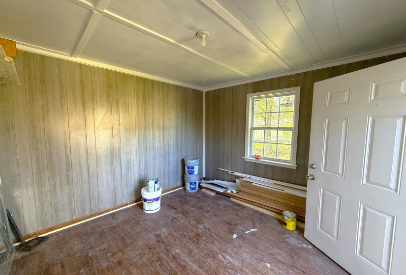 Empty room featuring wood walls and wood-type flooring
