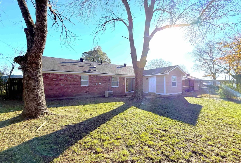 Rear view of property with brick siding and a shingled roof