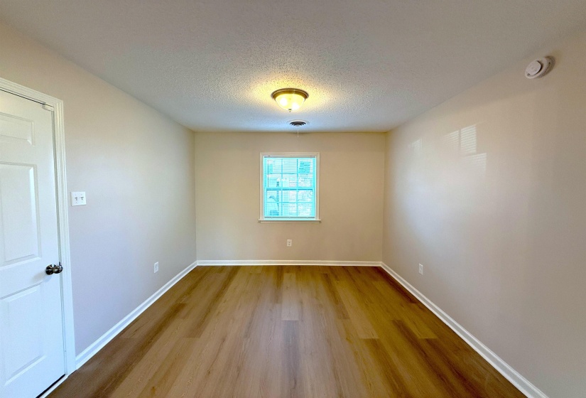 Spare room featuring a textured ceiling and light wood-style floors