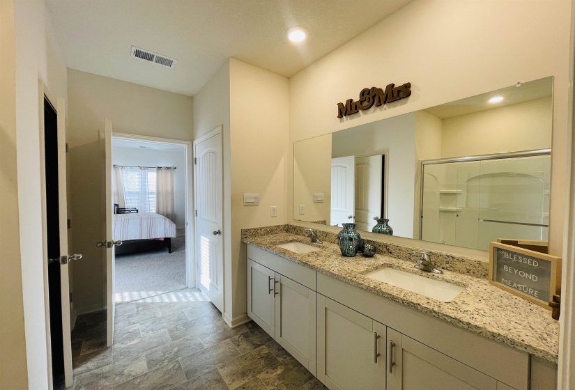 Ensuite bathroom with double vanity and a shower stall
