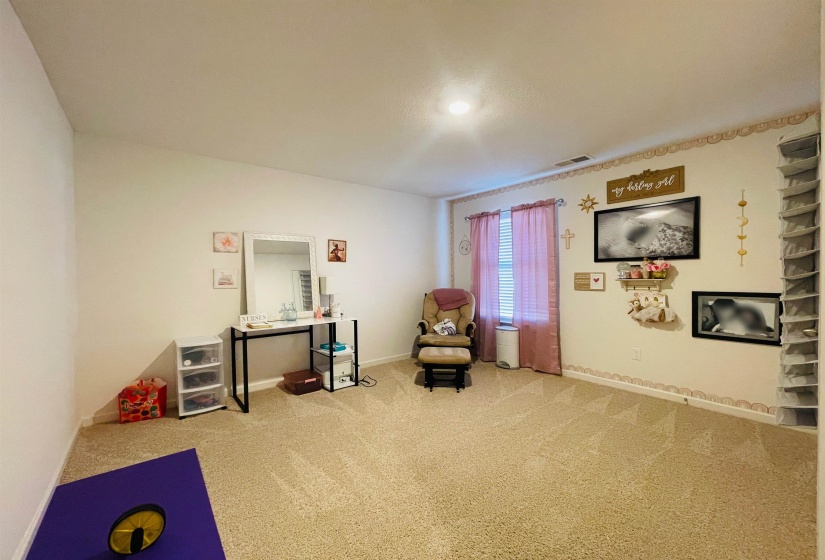 Living area with baseboards and carpet flooring