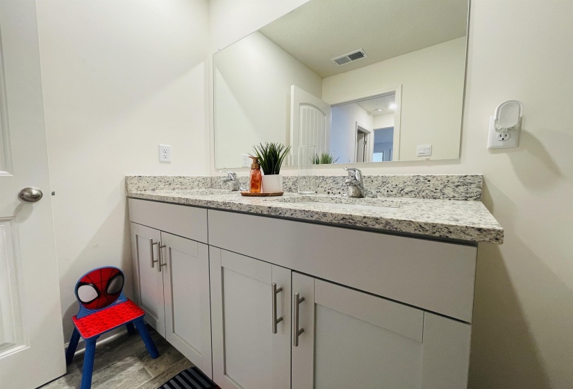 Full bath featuring double vanity