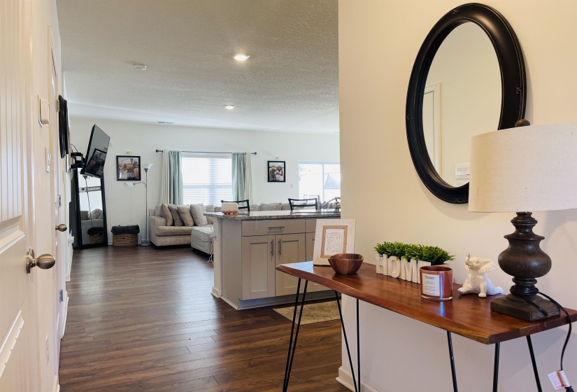 Hallway featuring dark wood-type flooring and a textured ceiling