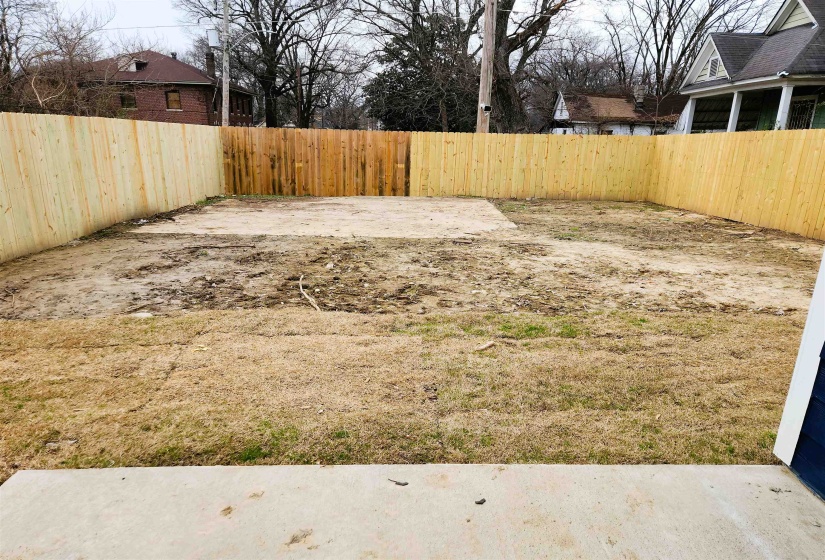 Fenced backyard with a patio