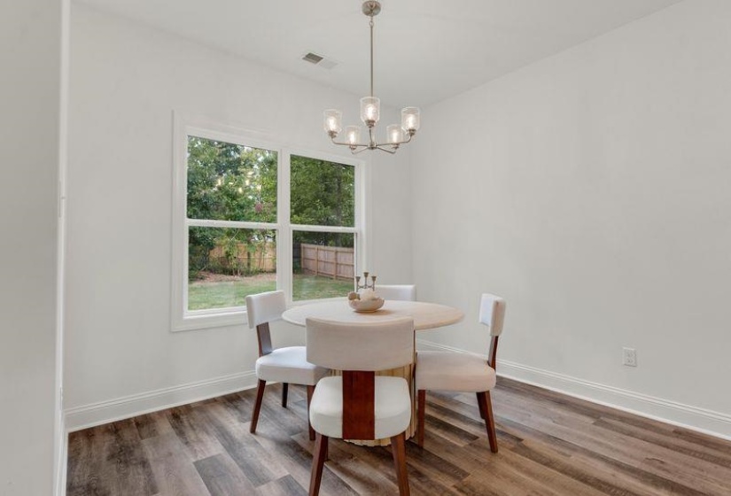 Dining space featuring wood finished floors and a chandelier