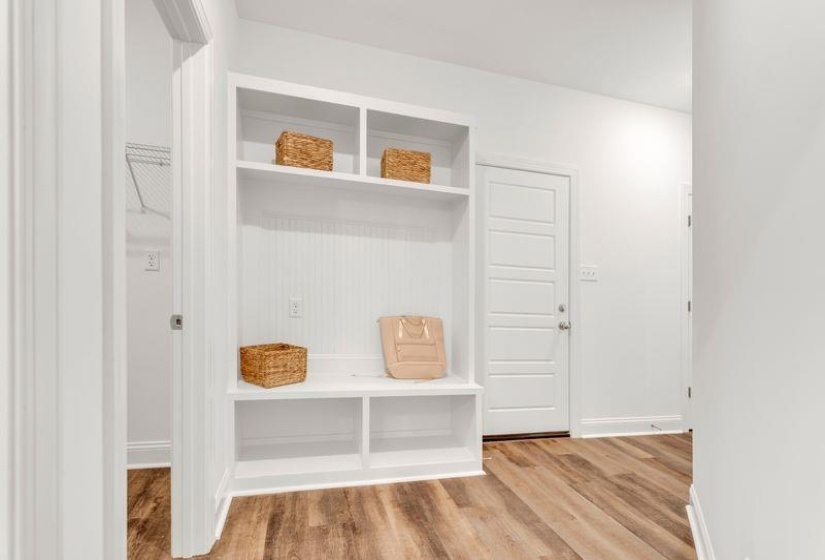 Mudroom featuring light wood-type flooring and baseboards